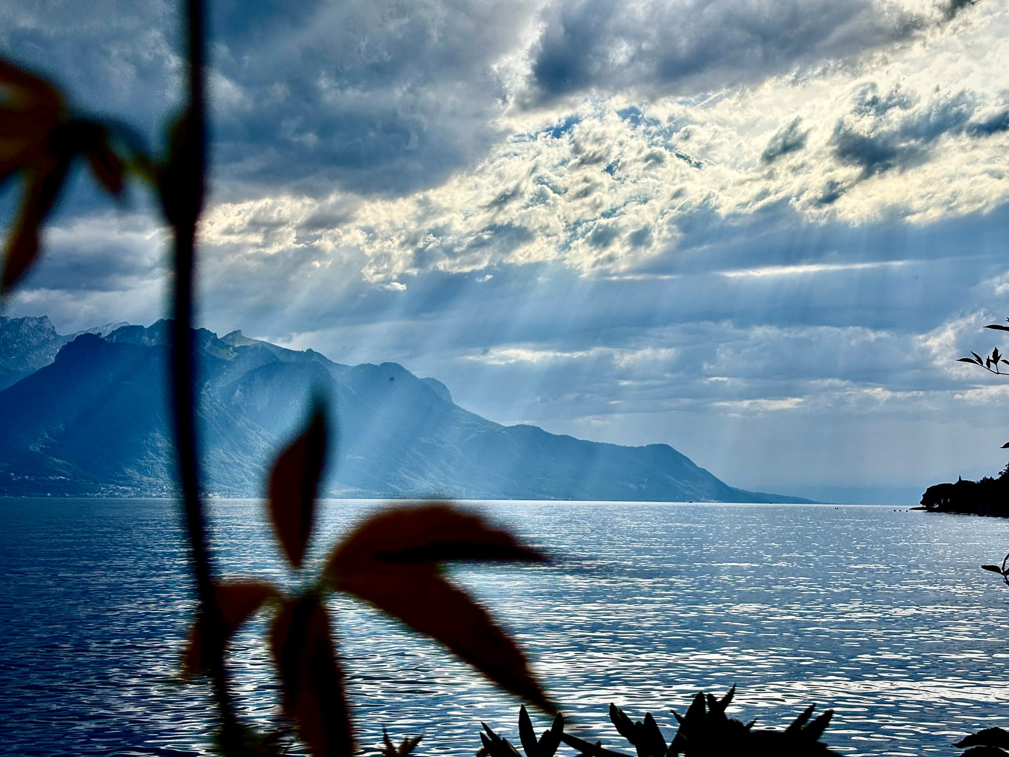clouds blocking the sun against the backdrop of mountains