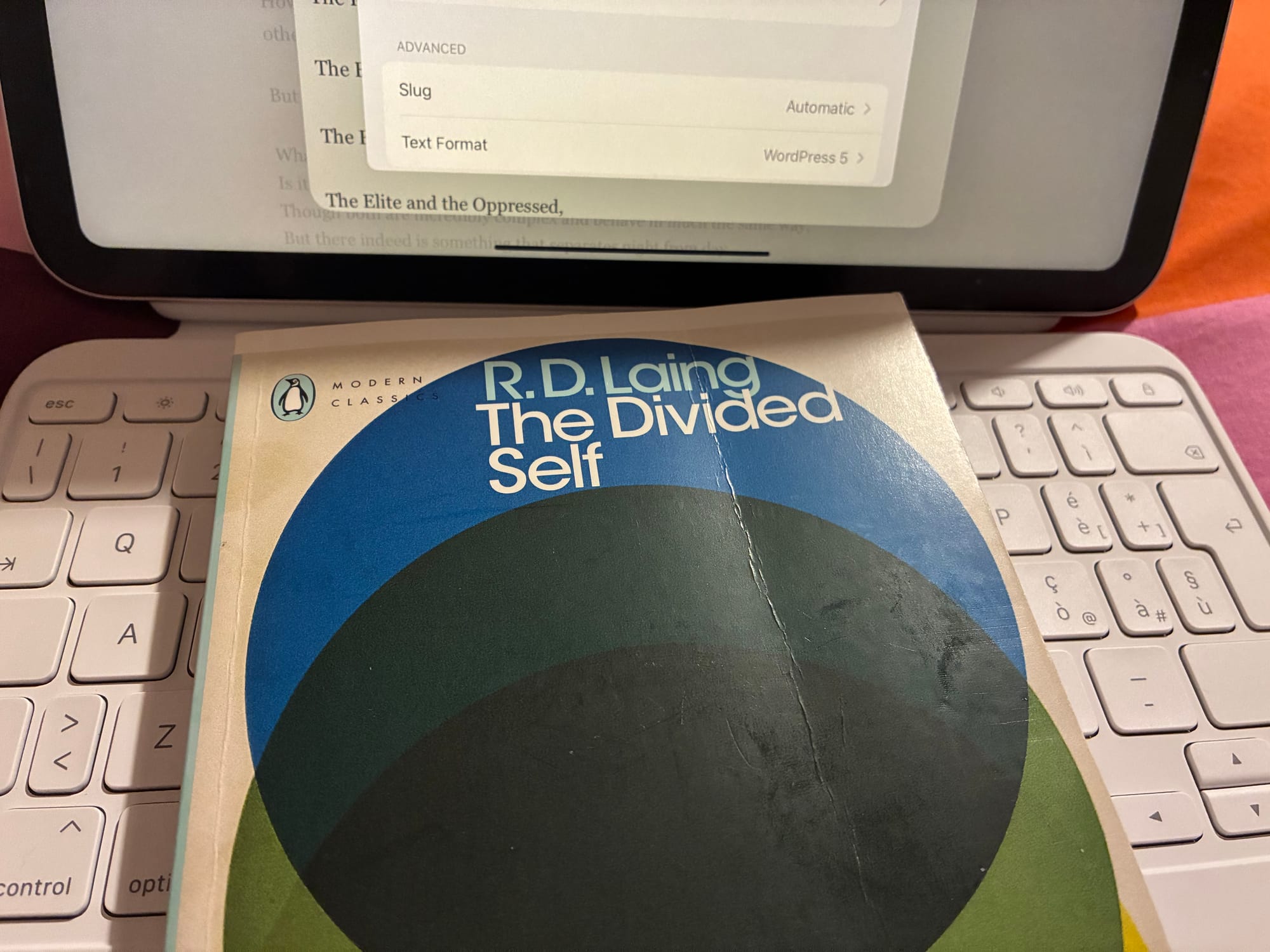 Picture of a book stacked on top of a keyboard