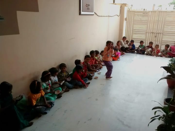 children eating and dancing inside a house